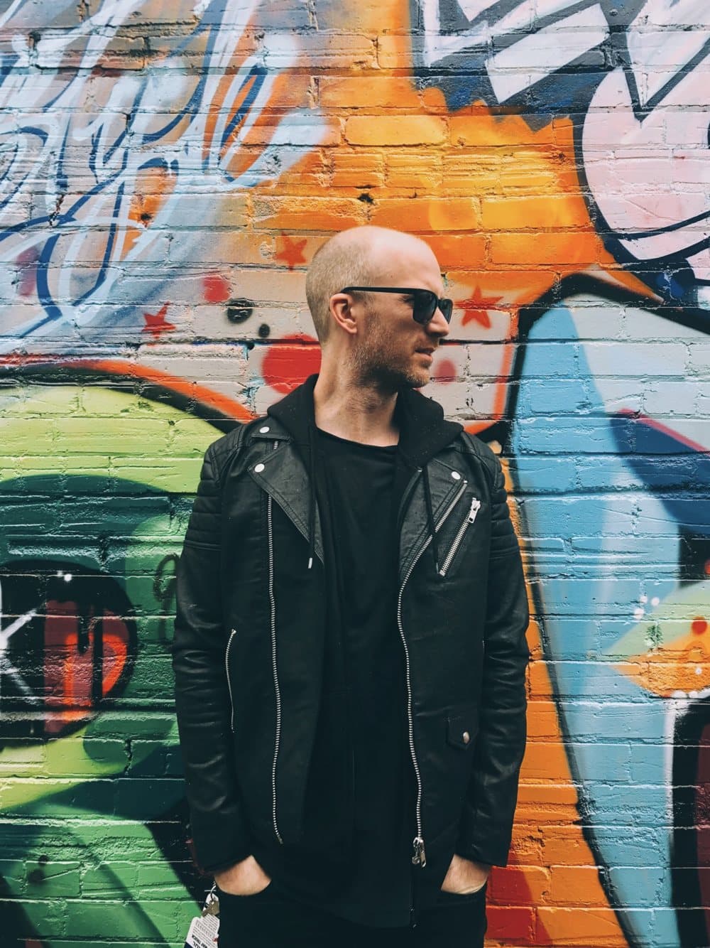 Nick de Partee, photographed against a graffiti wall